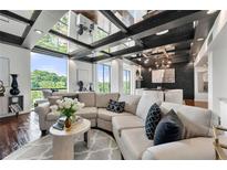 Bright living room features large windows, sleek finishes and a plush sectional sofa at 130 26Th Nw St # 801, Atlanta, GA 30309