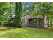 Charming home with stone accents, inviting porch, and lush greenery at 5245 Olde Mill Rd, Woodstock, GA 30188