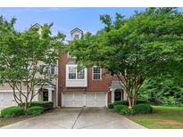 Charming two-story red brick home with attached two-car garage and mature landscaping at 6213 Indian Wood Cir, Mableton, GA 30126