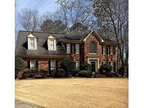 Charming brick home featuring a well-manicured lawn and traditional architectural design at 3580 Treeline Ne Pass, Roswell, GA 30075