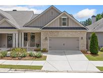 Charming townhome featuring a brick facade and attached two-car garage at 2499 Barrett Preserve Sw Ct, Marietta, GA 30064