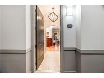 Welcoming entryway with tile flooring, chandelier lighting, and a view into the living area at 3621 Vinings Slope Se # 1231, Atlanta, GA 30339