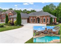 Beautiful brick home featuring a well-manicured lawn, a large driveway, and an in-ground pool with a waterfall feature at 1610 Turtle Pond Dr, Hoschton, GA 30548