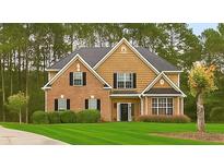 Charming two-story home featuring brick and wood siding, a manicured lawn, and mature trees, offering classic curb appeal at 3 Tiffany Trce, Palmetto, GA 30268