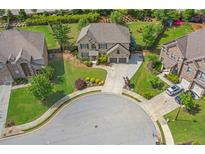 Aerial view of a beautiful brick home with well-manicured lawn and two-car garage on a cul-de-sac lot at 3179 Falls Crest Ct, Buford, GA 30519