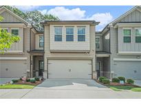 Charming townhome with a two-car garage, neutral siding, and well-maintained landscaping at 450 Rockfern Ct, Lilburn, GA 30047