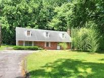 Charming brick home featuring a well-maintained lawn and mature trees, offering a serene and private setting at 1431 Woodland Sw Ter, Atlanta, GA 30311