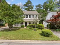 Charming two-story home featuring a well-manicured lawn, mature trees and classic black shutters at 3405 Haverhill Rowe, Lawrenceville, GA 30044