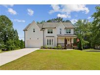 Beautiful two-story modern farmhouse with white siding, charming front porch, and well-manicured lawn at 3617 Carson Se Ln, Smyrna, GA 30080