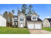 Charming two-story home with a two-car garage, well-maintained lawn, and classic curb appeal at 7071 Deshon Hills Ln, Lithonia, GA 30058