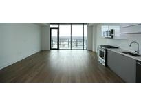Bright living room features a large window with city views and a modern kitchen at 788 W Marietta Nw St # 811, Atlanta, GA 30318