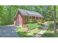 Charming brick home featuring a welcoming front porch and a convenient two-car garage at 150 Gill Ln, Stockbridge, GA 30281
