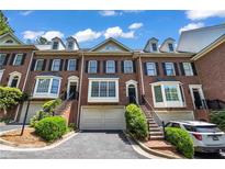 Charming brick townhome with well-maintained landscaping, private entrances, and attached garages at 1735 Peachtree Ne St # 624, Atlanta, GA 30309
