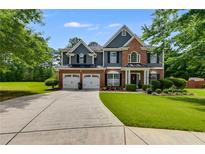 Charming two-story home with a well-manicured lawn and a spacious driveway leading to a two-car garage at 7115 Secret Rose, Douglasville, GA 30134