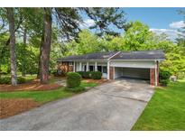 Charming single-story home with brick accents, a covered carport, and a well-manicured lawn at 4616 Greensprings Rd, Atlanta, GA 30337