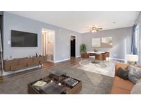 Bright living room features hardwood floors, modern furnishings, and a dining area at 1151 Rankin St # 20A, Stone Mountain, GA 30083