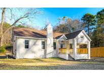 Charming single-story home with a welcoming front porch and nicely maintained landscaping at 5510 Mason Rd, Atlanta, GA 30349