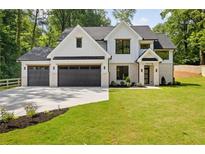 Beautiful two-story home with a three car garage, black framed windows, and fresh landscaping at 1870 Twin Branch Dr, Marietta, GA 30062