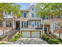 Beautiful townhouse with a brick facade, two-car garage, and charming curb appeal, perfect for modern living at 5882 Riverstone Cir # 15, Atlanta, GA 30339