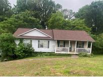 Charming single-story home with a welcoming front porch and well-maintained lawn at 501 Textbook Ct, Lawrenceville, GA 30044