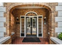 Charming brick entryway with double doors and arched details offers a warm and inviting welcome at 242 12Th Ne St # 1A, Atlanta, GA 30309