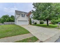 Charming two-story home with a two-car garage and a well-manicured front yard at 2355 Glen Chase Ln, Lawrenceville, GA 30044