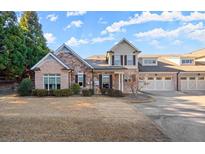 Beautiful brick home with a three-car garage and manicured lawn at 2797 Middlecreek Way, Cumming, GA 30041