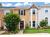 Inviting townhome featuring a well-manicured lawn and mature landscaping at 4971 Jenny Dr, Acworth, GA 30101