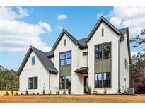 Beautiful modern two-story home with light brick, dark trim, and manicured landscaping on a sunny lot at 3735 Tamiami Trl, Cumming, GA 30041
