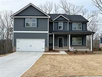 Charming two-story home with a two-car garage, inviting porch, and craftsman-style details at 5547 Bent Grass Way, Douglasville, GA 30135