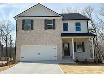 Charming two-story home featuring a two-car garage, light brick facade, and stylish black shutters at 18 Loth Wages (Lot 18) Rd, Dacula, GA 30019