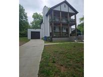 Charming two-story home with a large front yard, two porches, and an attached garage at 1228 Ladd Sw St, Atlanta, GA 30310