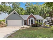 Charming single-story home with gray siding, brick accents, and a well-manicured front yard at 231 Clarion Rd, Lawrenceville, GA 30043