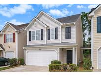 Charming two-story home featuring a one-car garage and beautifully maintained front yard at 50 Fieldview Ln, Covington, GA 30016
