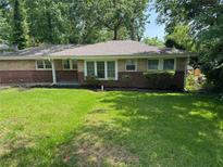 Charming brick home featuring a well-manicured lawn and mature trees at 2903 Santa Barbara Dr, Decatur, GA 30032