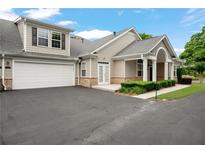Charming home featuring a two-car garage, manicured landscaping, and inviting curb appeal at 2561 Grapevine Cir # 104, Cumming, GA 30041