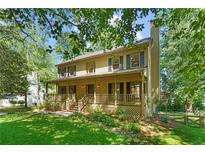 Charming two-story home with a welcoming front porch and manicured lawn at 2120 Habersham Trce, Cumming, GA 30041