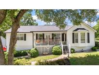 Charming home with a welcoming front porch, landscaped yard and classic white siding and black shutters at 2675 Springside Ct, Douglasville, GA 30135
