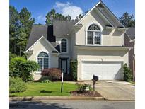 Traditional two-story home with arched windows, a well-manicured lawn, and a two car garage at 3773 Summer Rose Dr, Atlanta, GA 30341