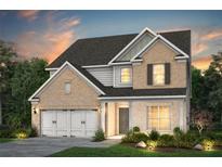 Beautiful two-story home with brick and siding exterior, attached two-car garage, and manicured front lawn at 4297 Azalea Ridge Way, Hoschton, GA 30548