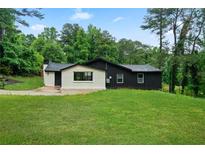 Charming home featuring a spacious front yard and stylish two-tone exterior at 980 Porter Rd, Decatur, GA 30032