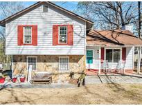Charming home with stone accents, red shutters, and a welcoming front porch at 1040 Forest East Dr, Stone Mountain, GA 30088
