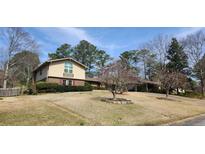 Two-story home with a well-manicured lawn and mature trees at 2886 Thornbriar Rd, Atlanta, GA 30340