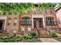 Charming brick townhome with multiple stories, a landscaped front yard, and a welcoming front entrance at 2548 Crescent Park Ct # 7, Atlanta, GA 30339