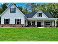Charming new construction home featuring a manicured lawn and inviting front porch at 8145 Lakeview Pkwy, Villa Rica, GA 30180