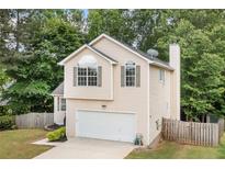 Charming two-story home featuring an attached garage and well-maintained front yard at 503 Fable Ln, Canton, GA 30114