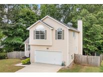 Charming two-story home with vinyl siding, attached garage, and landscaped front yard at 503 Fable Ln, Canton, GA 30114