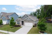 Charming one-story home with brick accents, well-manicured lawn, and a concrete driveway at 7570 Rambling Vale, Cumming, GA 30028