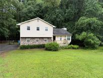 Charming two-story home with stone accents and a well-manicured front lawn at 2523 Bronco Trl, Duluth, GA 30096