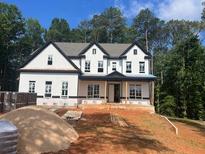 New two-story home featuring white siding, black trim, and symmetrical windows at 3425 Dr Bramblett Rd, Cumming, GA 30028